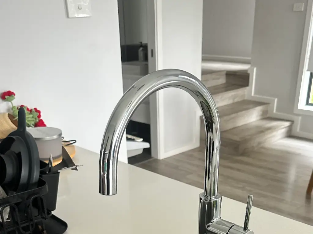 Newly installed matte black gooseneck kitchen mixer tap in a renovated Western Sydney kitchen